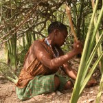 Hadzabe woman digging up a tuber